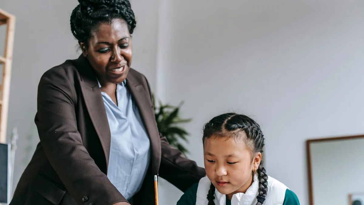 Tutor explaining a question to a young student during a one-on-one lesson